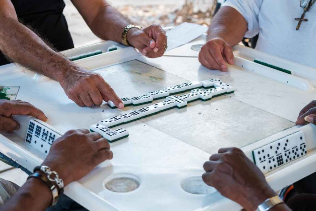 four men playing dominoes at Domino Park in little havana in Miami
