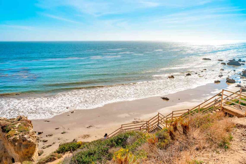 wooden stairs leading down to el matador beach in southern california on the pacific ocean