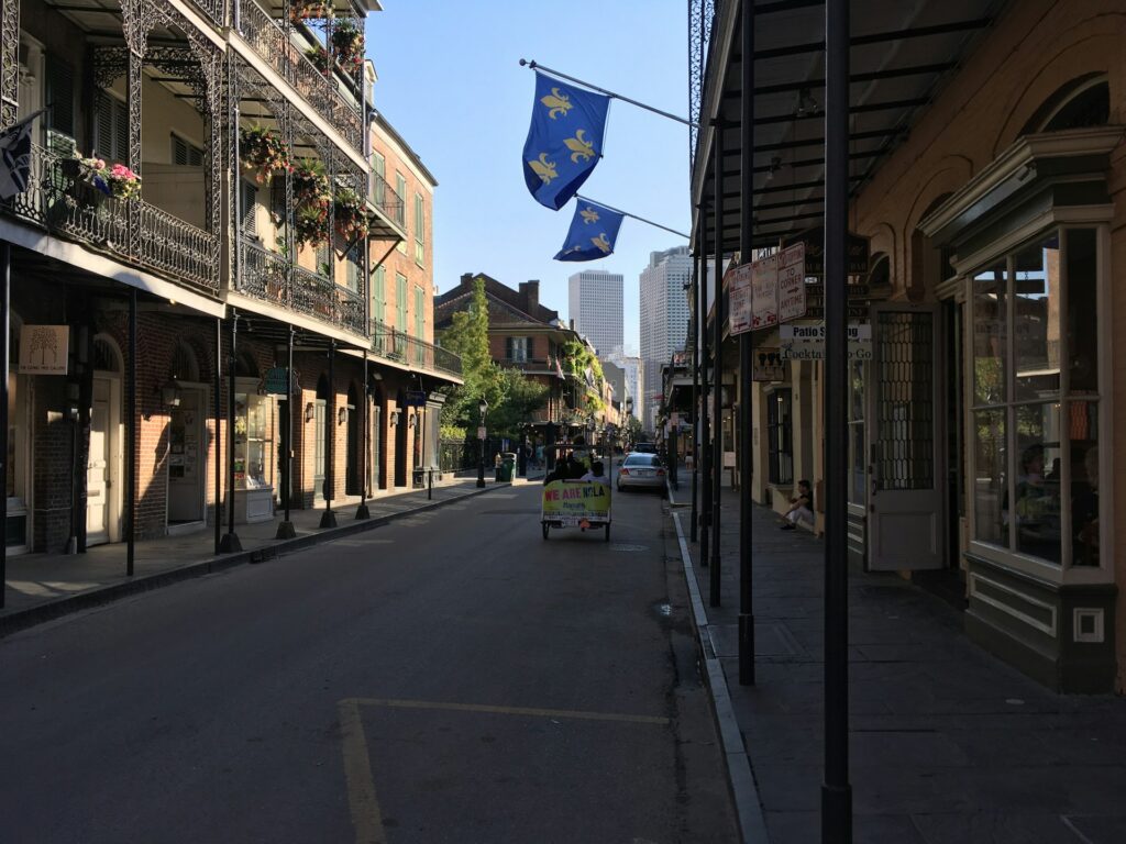 View of a city street in New Orleans with a flag on a pole.