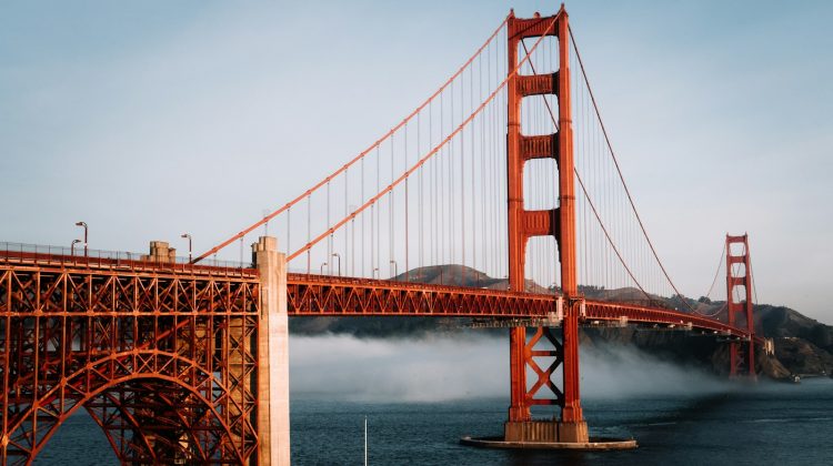 The Golden Gate Bridge in San Francisco, California, with fog rolling across the bay beneath its red towers