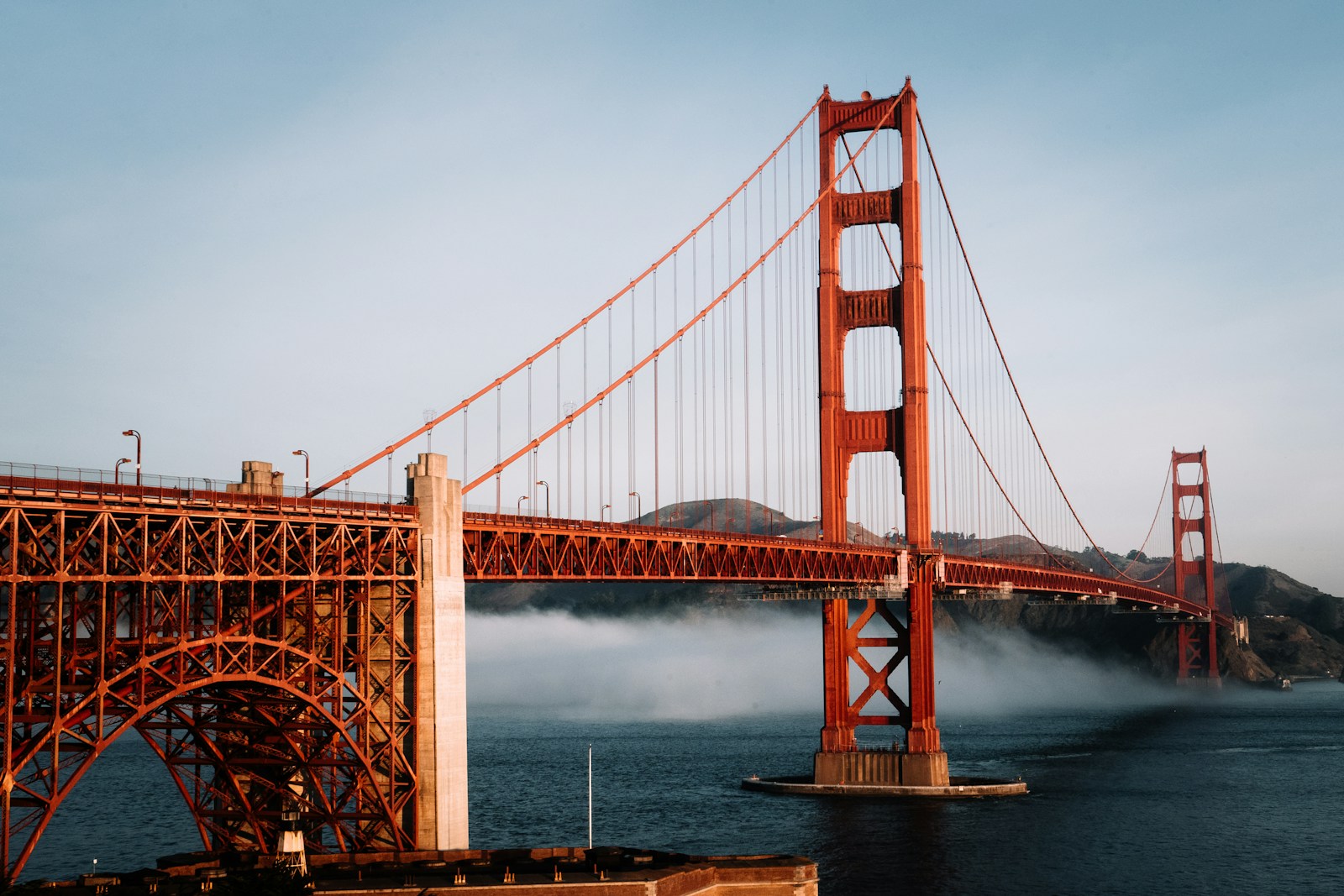 The Golden Gate Bridge in San Francisco, California, with fog rolling across the bay beneath its red towers